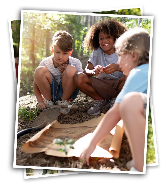 Three kids in the woods, smiling and studying a map at summer camp, perhaps they are on a hike or a treasure hunt