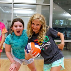 2 girls having fun in the gym at summer camp, ymca