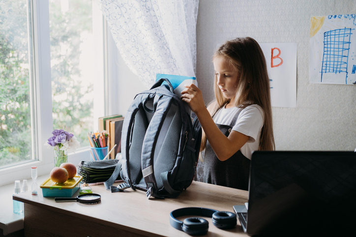Girl packing her Backpack