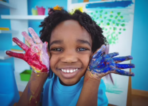 art factory summer camper with paint on hands